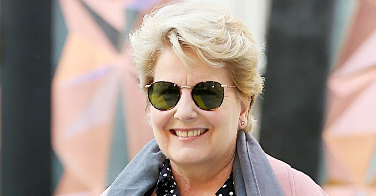 Sandi Toksvig smiles on the red carpet in sunglasses