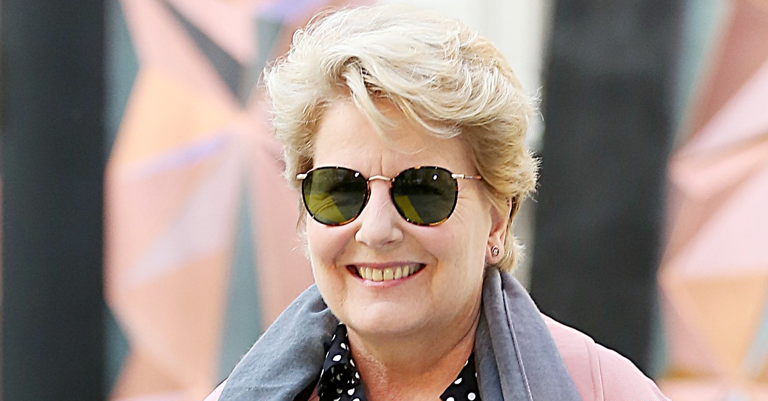 Sandi Toksvig smiles on the red carpet in sunglasses