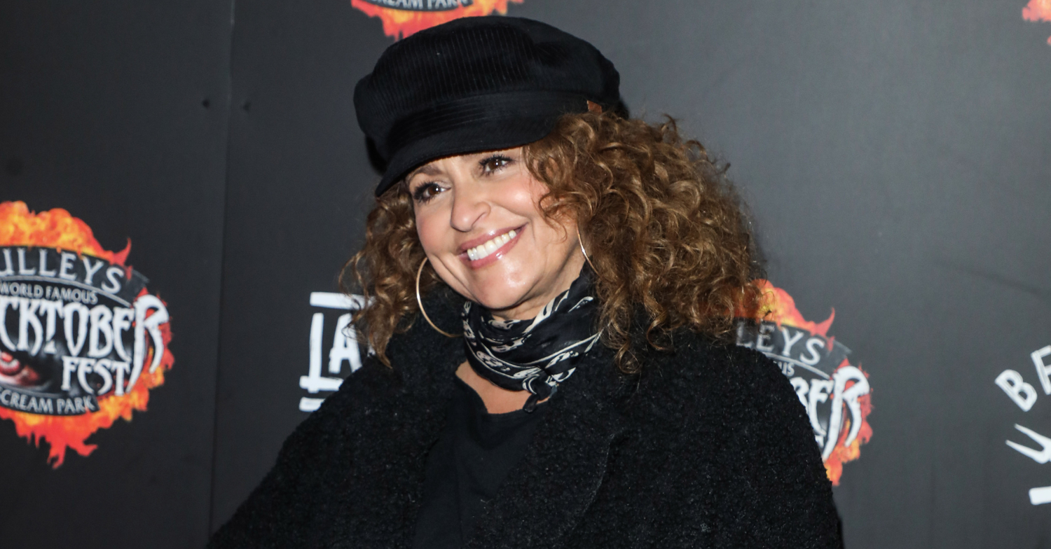 Nadia Sawalha wearing a black hat posing for photos