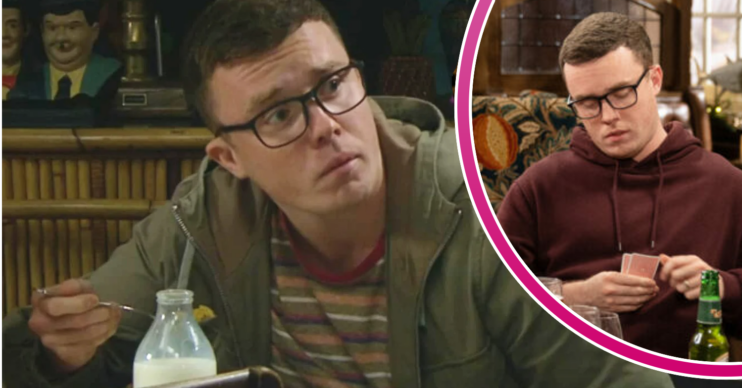 Vinny looking worried and looking at a deck of cards in Emmerdale