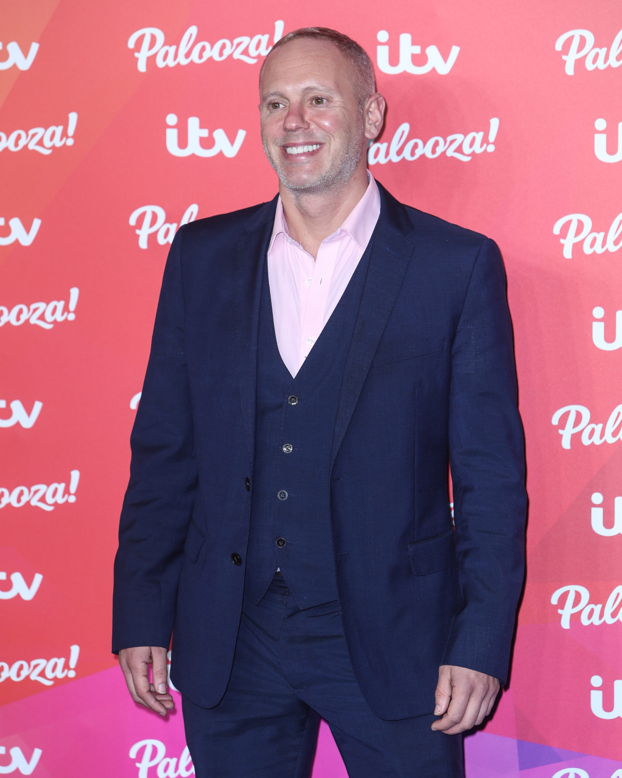 Rob Rinder smiling on the red carpet