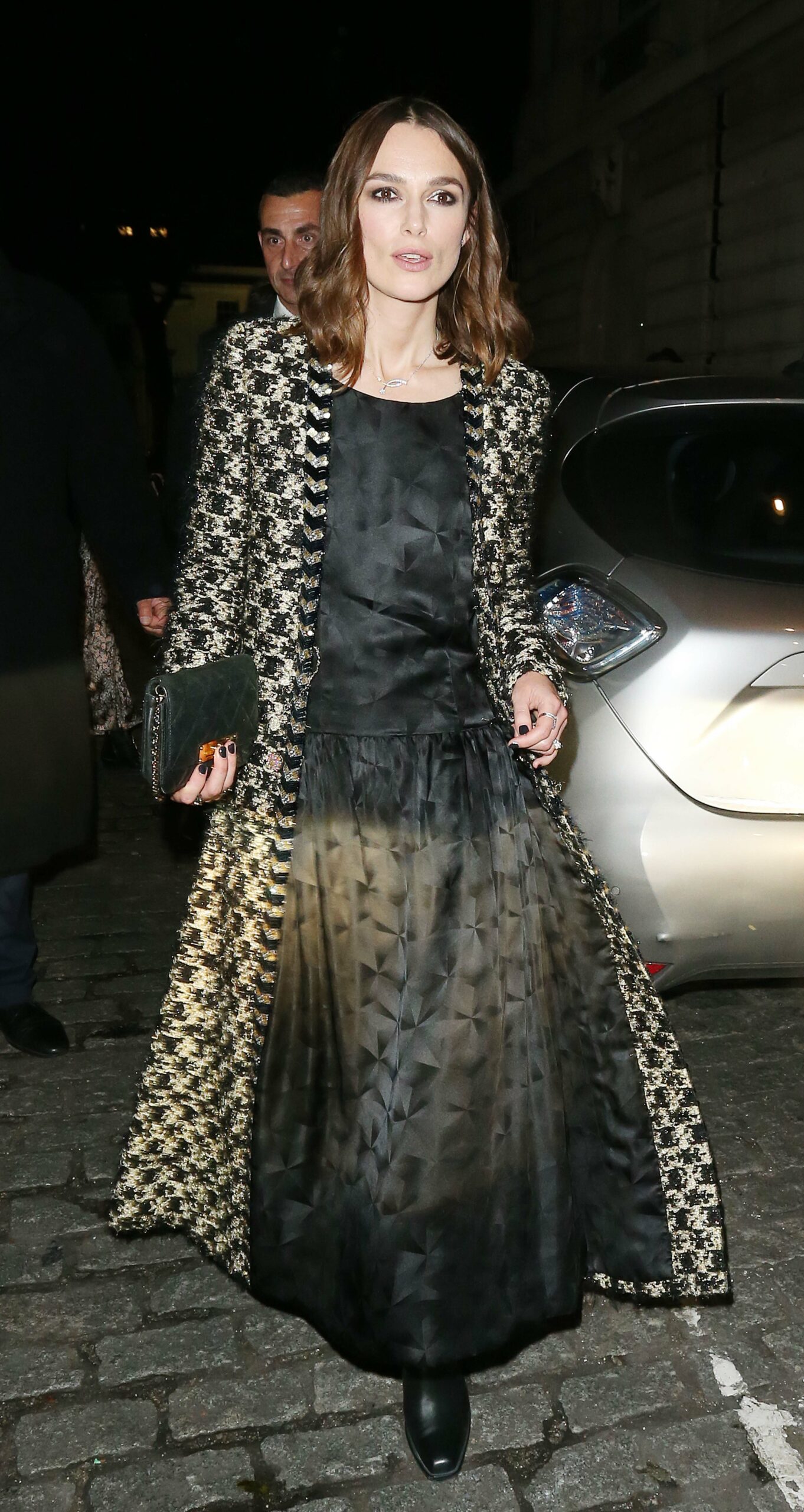 Keira Knightley in a metallic coat in the street