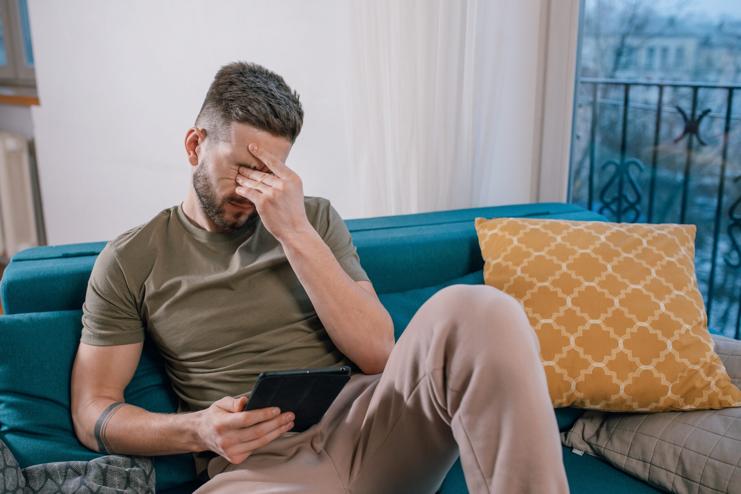 Man rubbing his eyes looking stressed