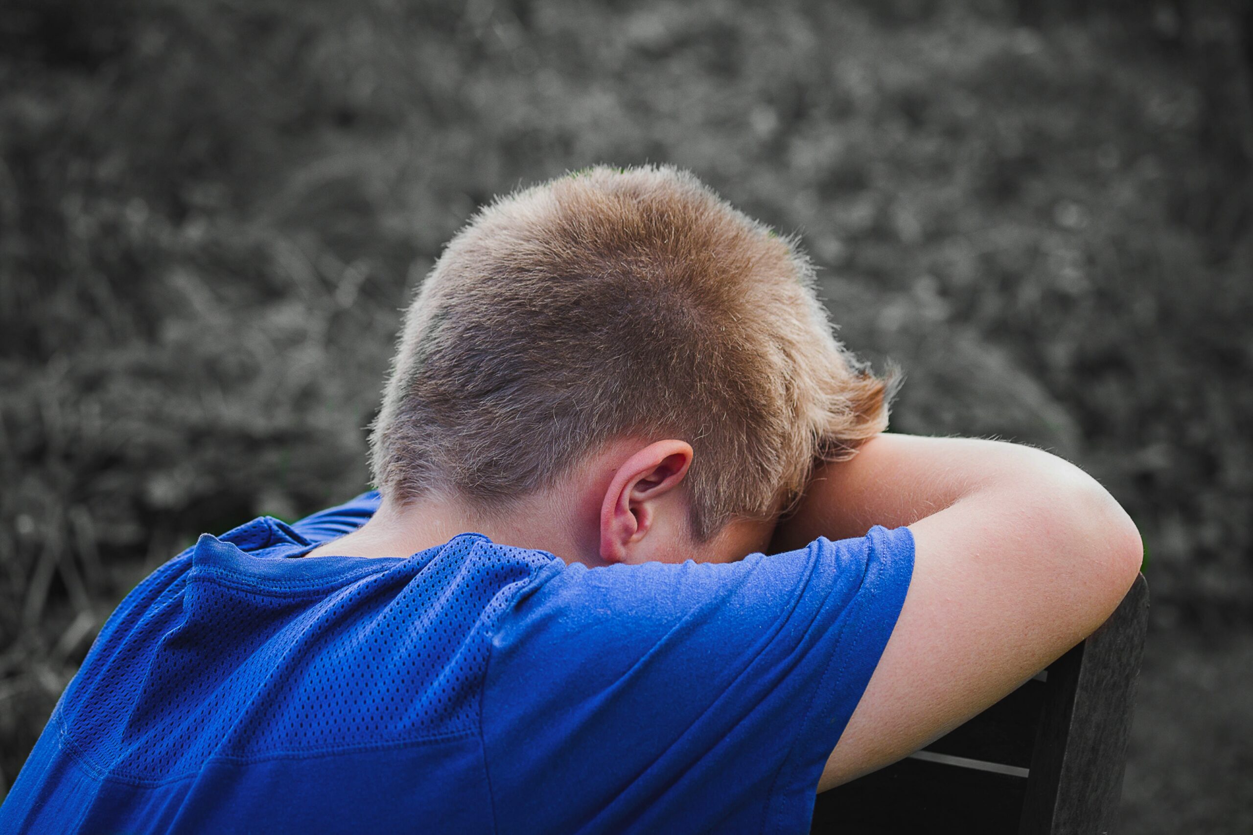 Child crying with his head in his hands