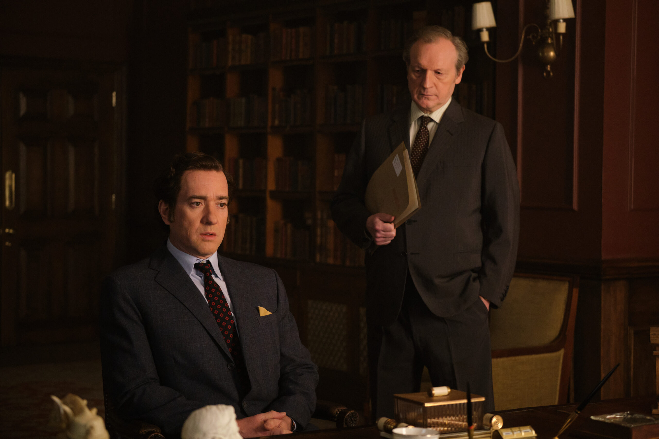 John Stonehouse and Charles Elwell have a discussion in a office