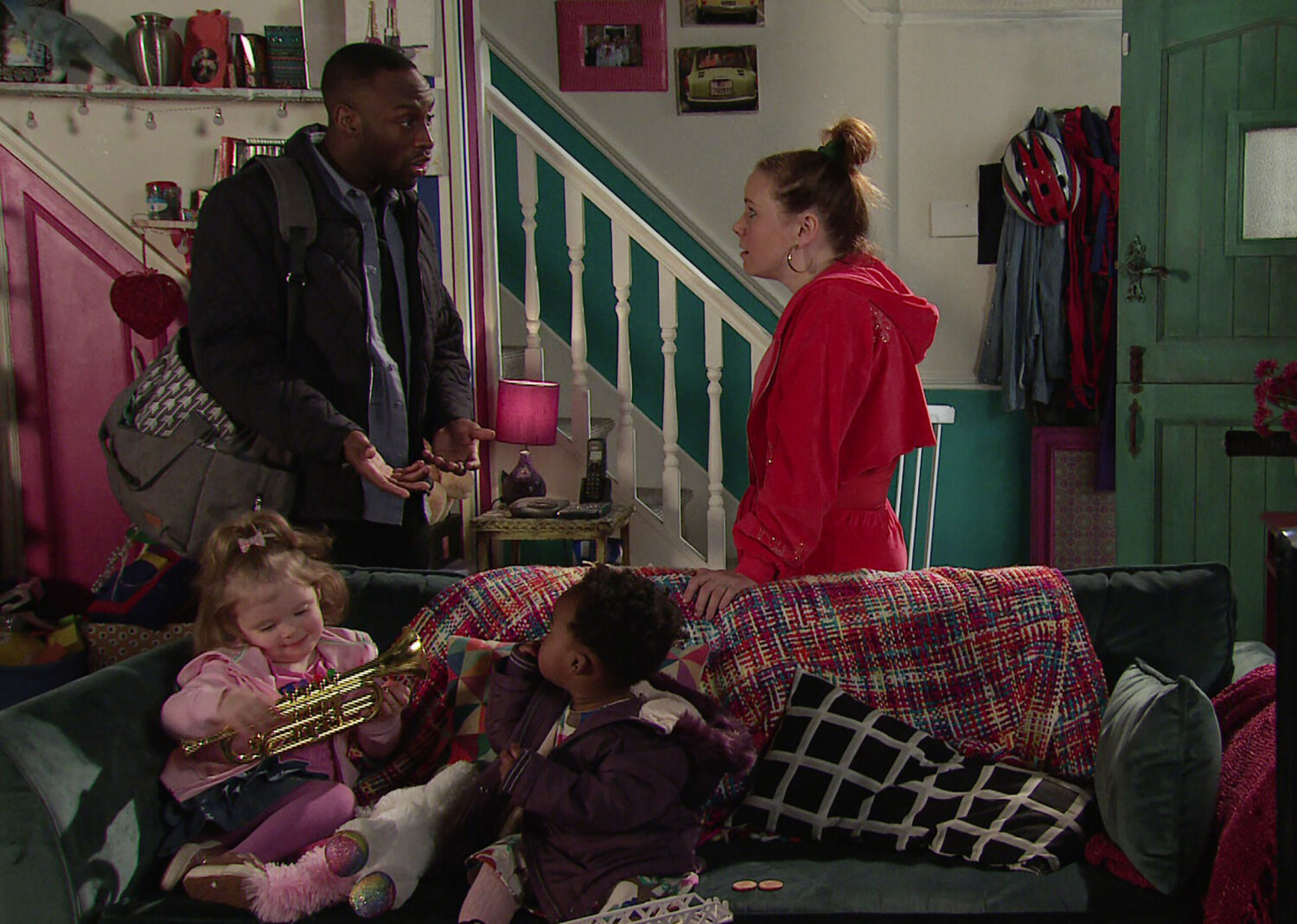 David and Gemma talk intensely, as the children play on Coronation Street