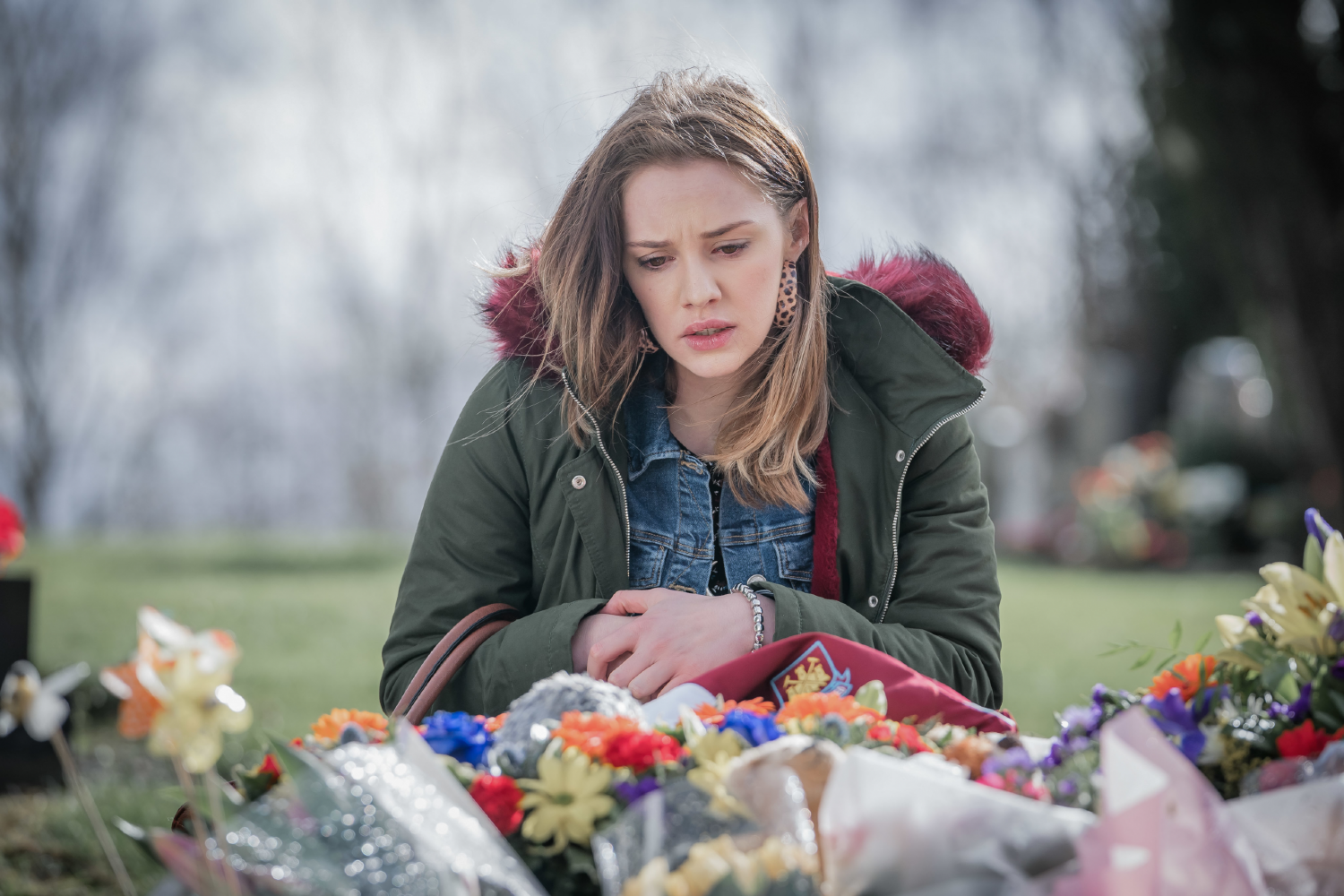 Mollie Winnard sitting amongst flowers in Happy Valley