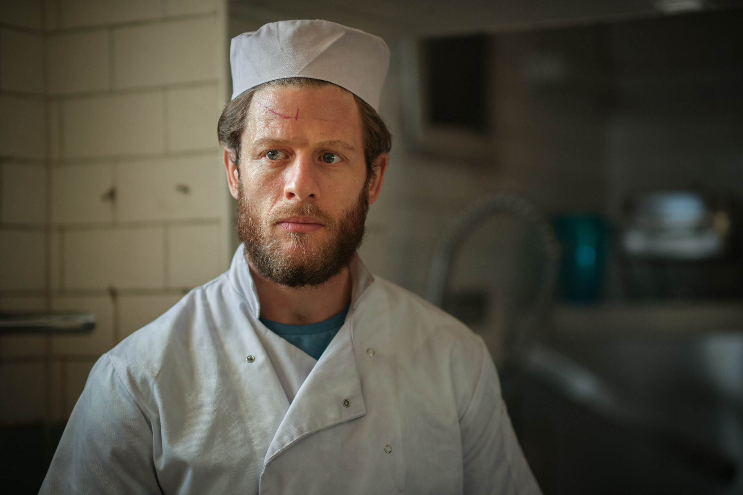Tommy frowns in the prison kitchen in Happy Valley series 3