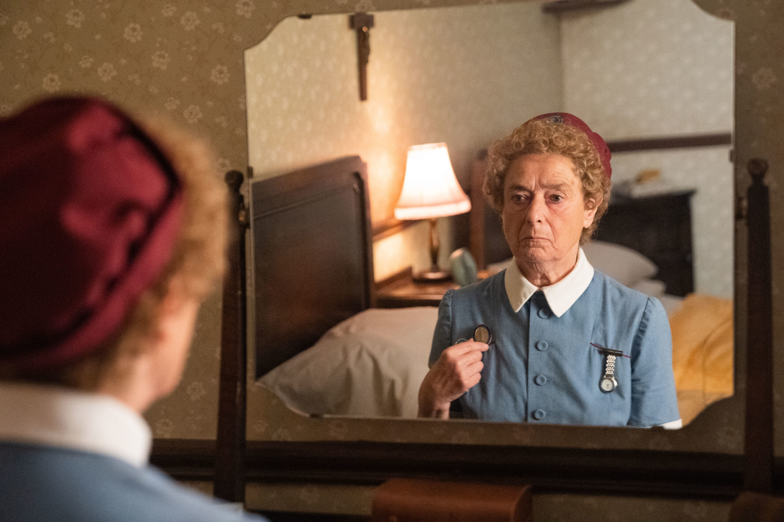 Nurse Crane frowns in the mirror in Call the Midwife