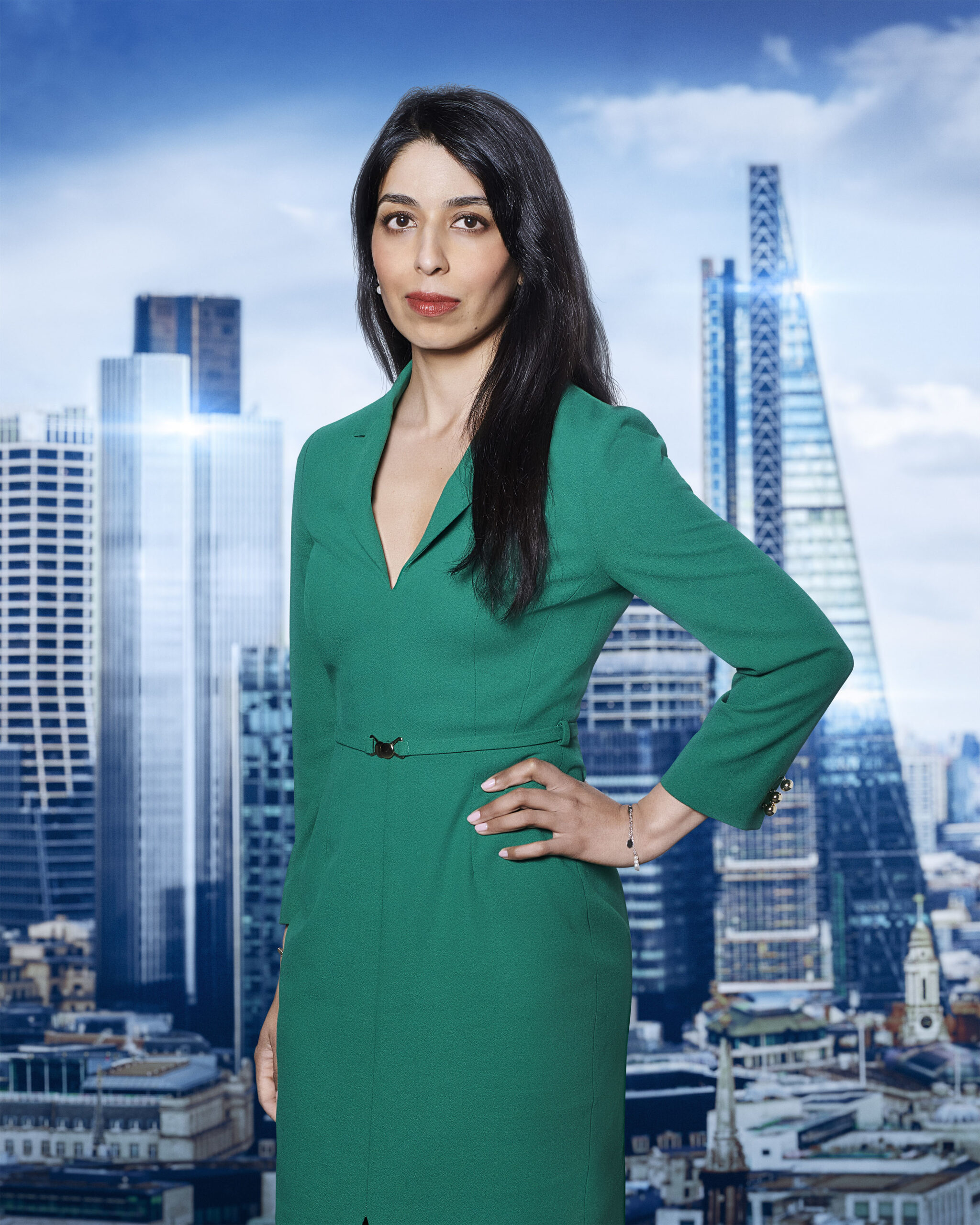 Shazia Hussain poses in green dress on The Apprentice