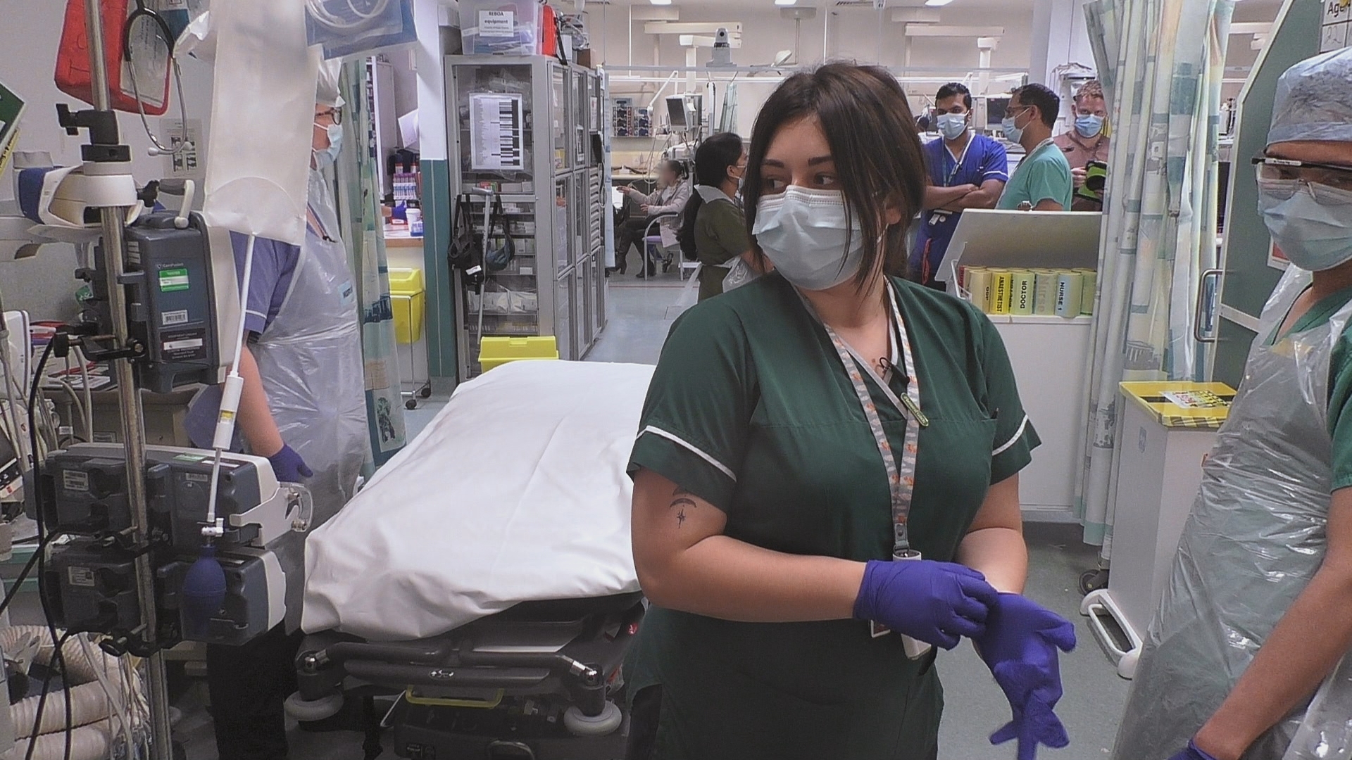 Iona removes her gloves in 24 Hours in A&E