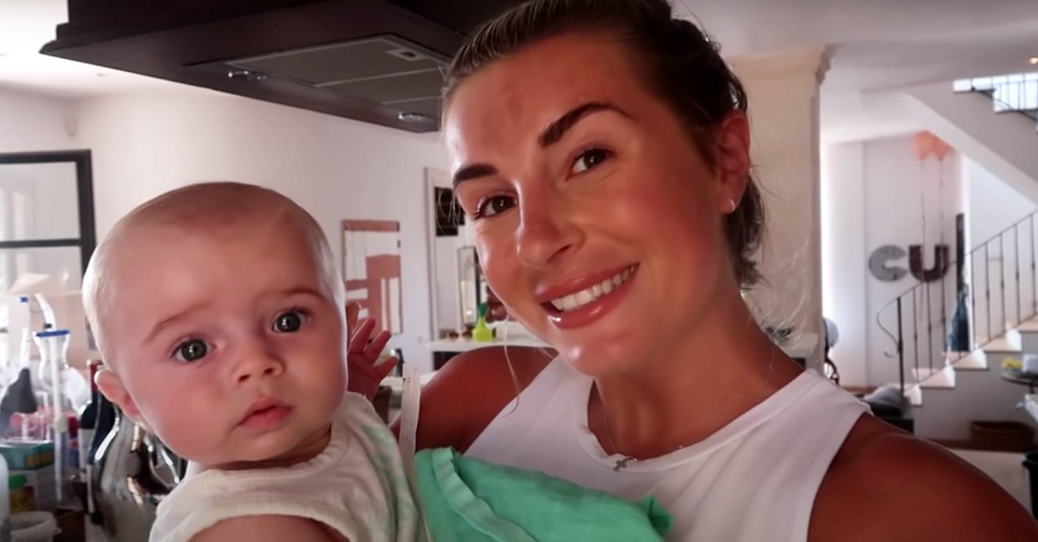 Dani Dyer smiles as she holds baby Santiago