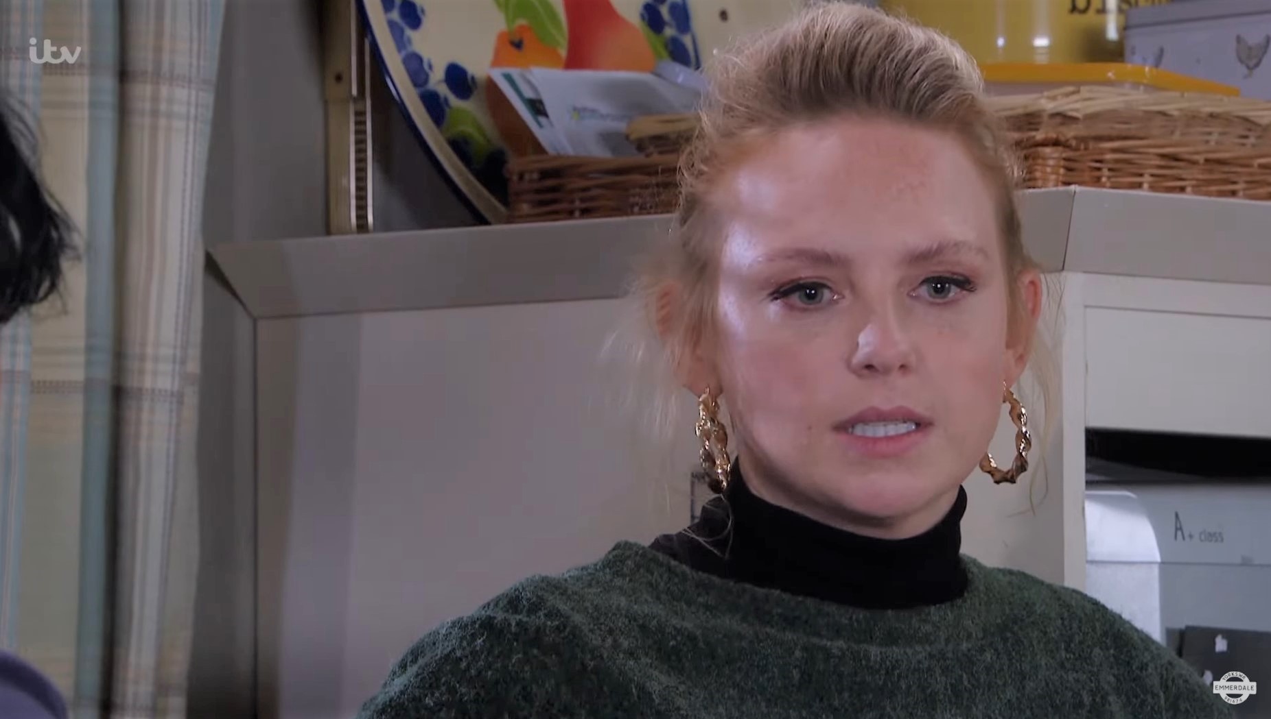 Emmerdale's Amy looks upset and worried in the kitchen at Moira's 