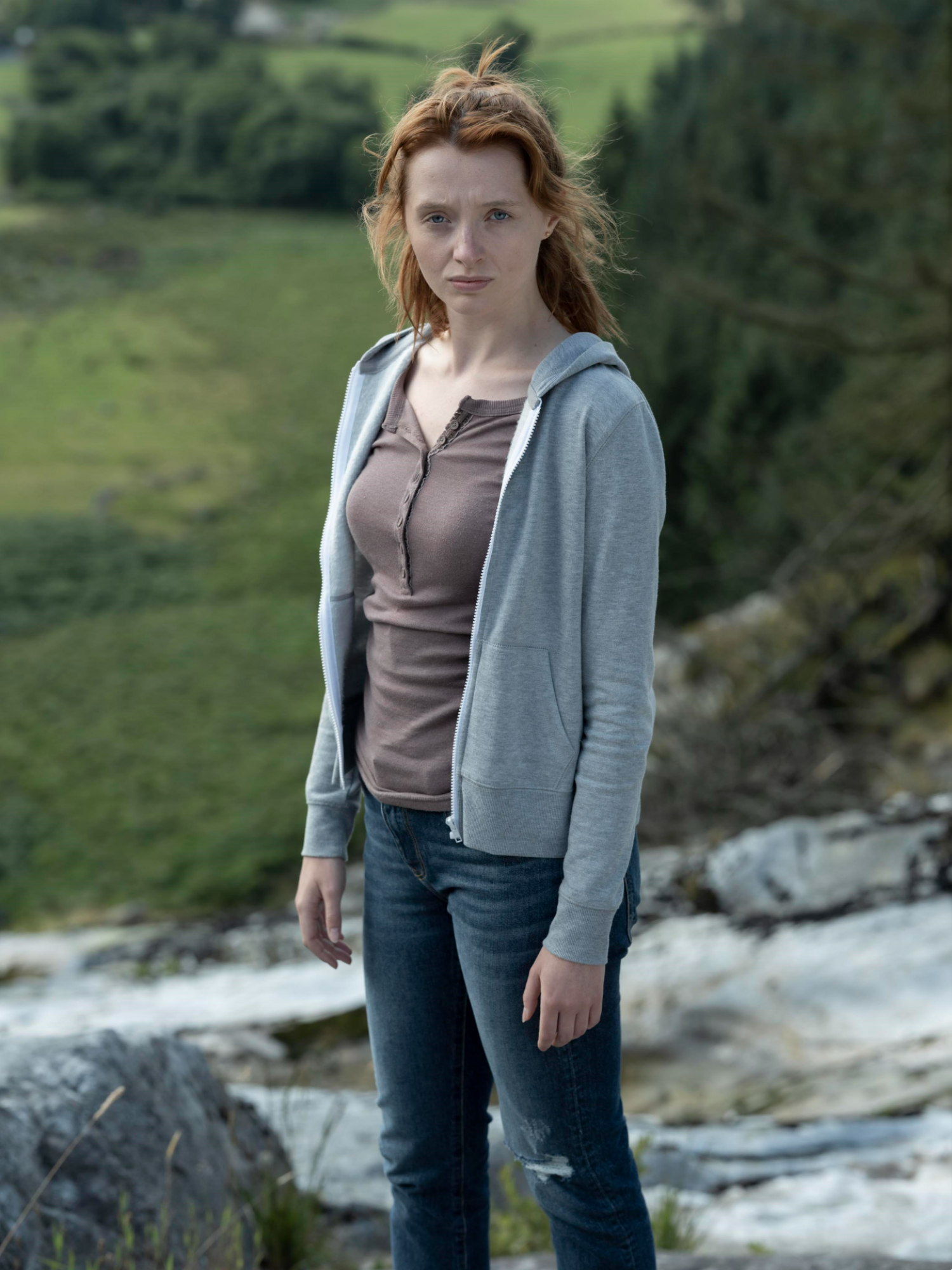 Poppy Gilbert posing in a field in The Catch