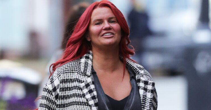 Kerry Katona smiles with red hair in pap shot