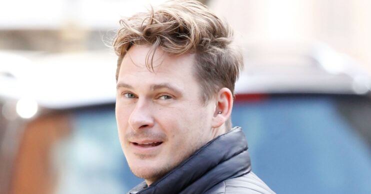 Blue singer Lee Ryan smiling over his shoulder