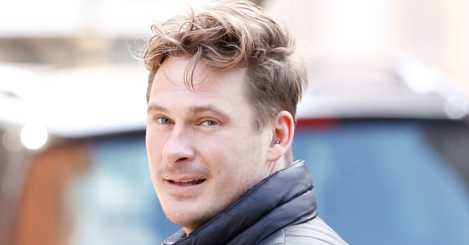 Blue singer Lee Ryan smiling over his shoulder