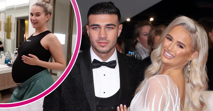 Molly-Mae Hague and Tommy Fury posing and showing her bump