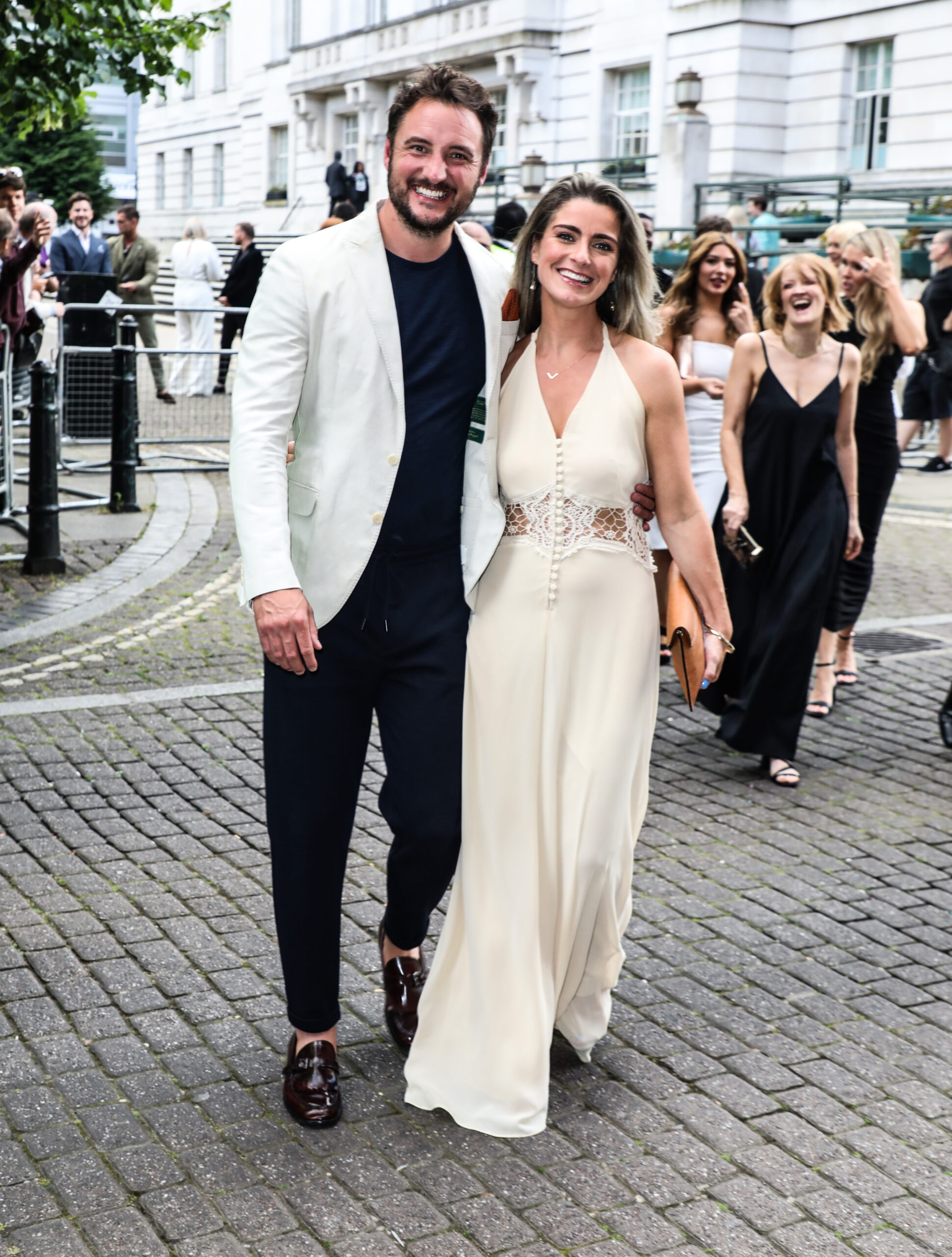 James Bye smiling with wife Victoria in a white dress
