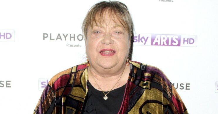 Sylvia Syms looking at camera at event