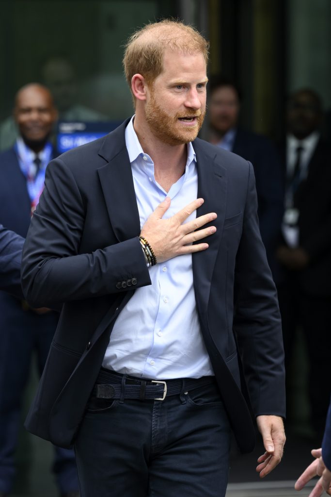 Prince Harry with hand on his chest 