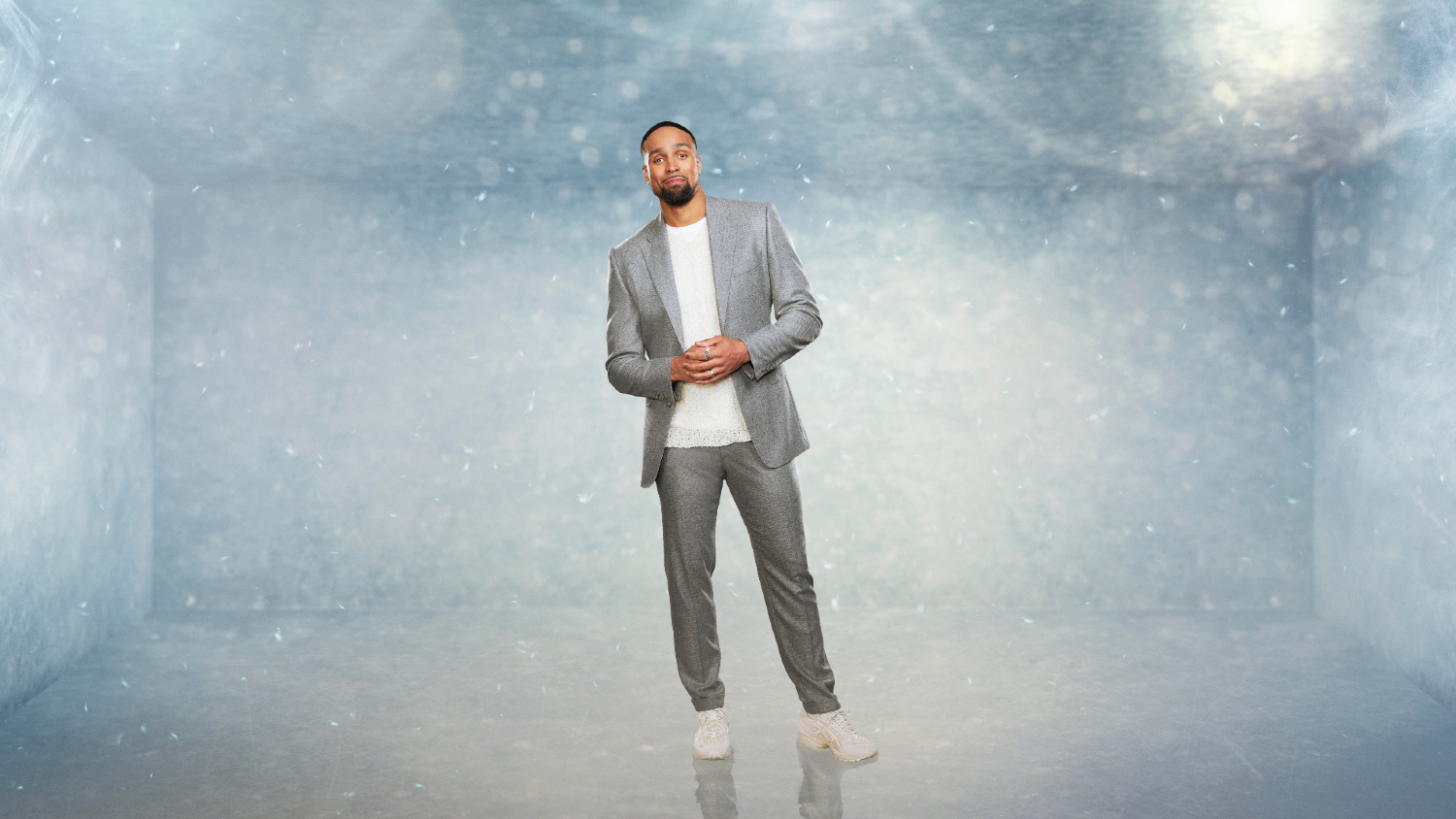 Ashley Banjo posing in a grey suit on Dancing On Ice 2023