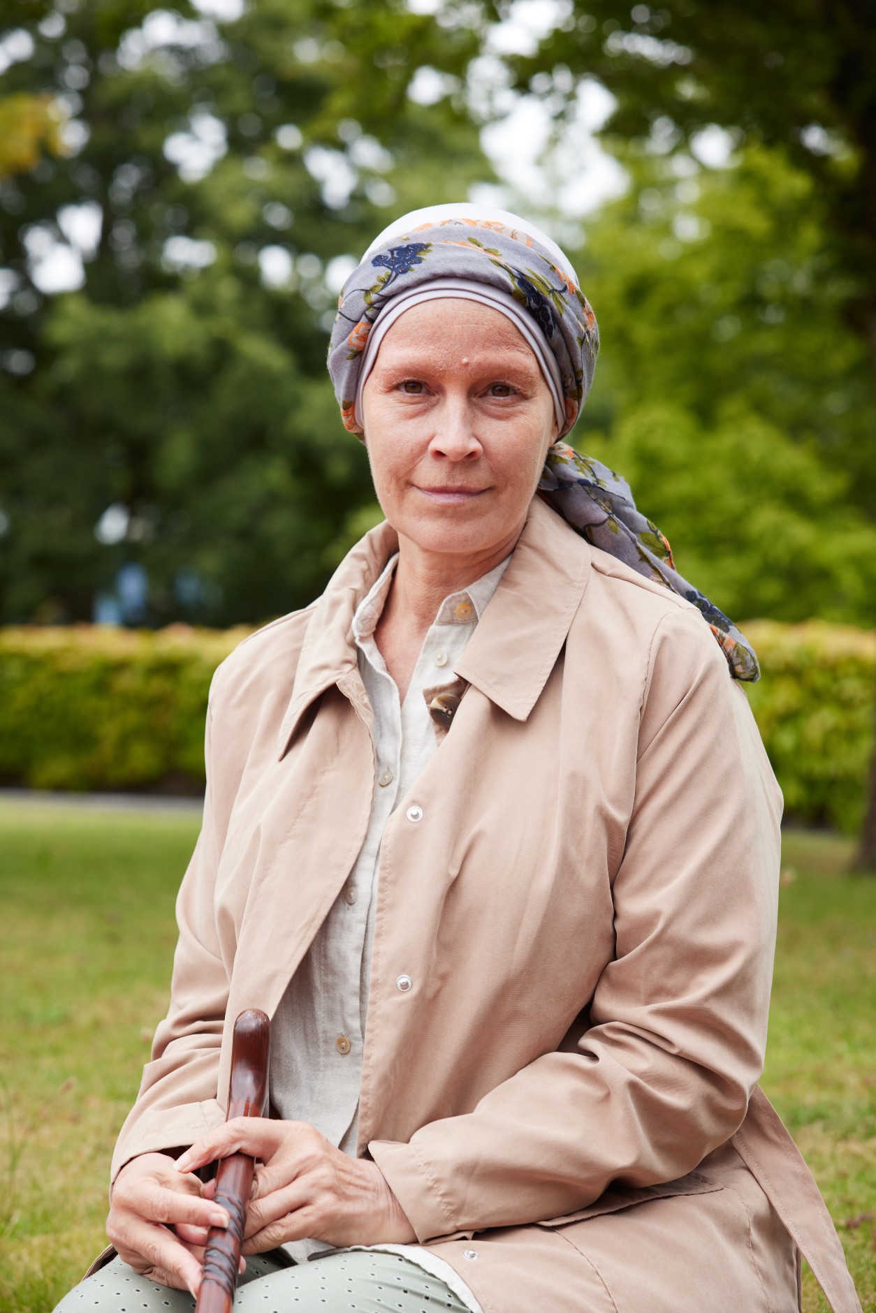 Sally Thomason sits and smiles outside in Maternal