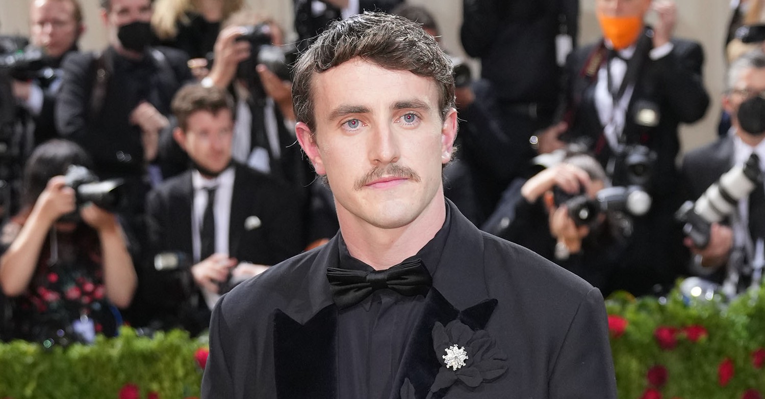 Paul Mescal posing for cameras with a moustache 