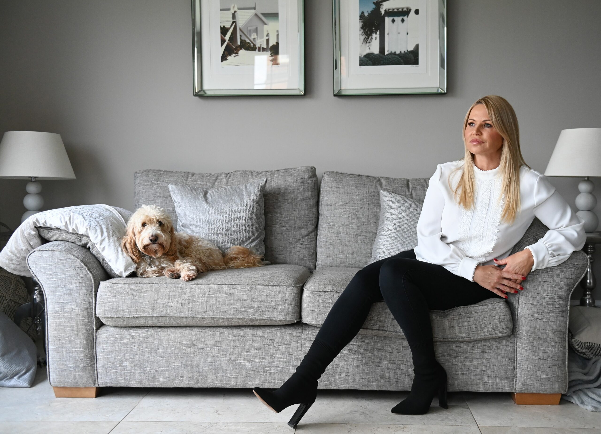 Louise Speed sits on a sofa