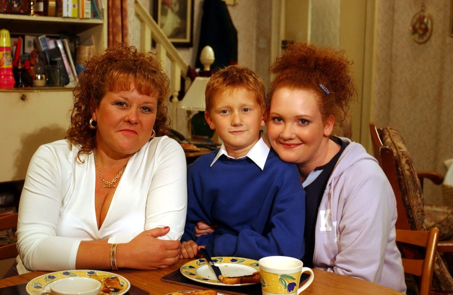 Coronation Street's Brown family: Cilla, Chesney and Fiz smile at the table