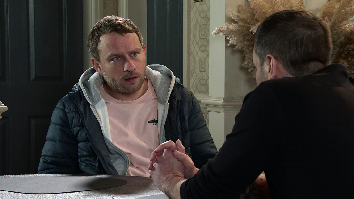 Paul looks surprised as he talks to Peter in Corrie