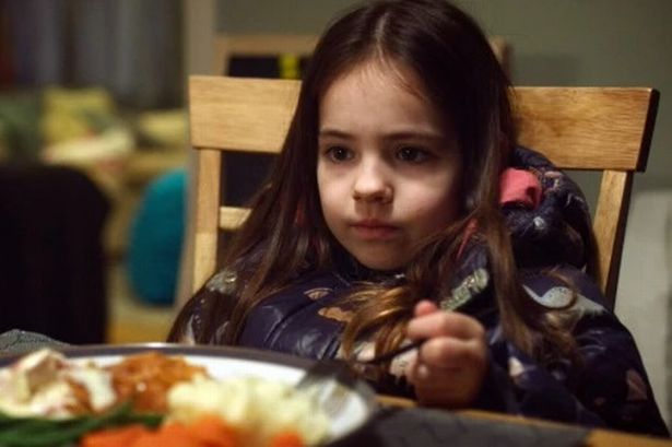 Poppy Hepworth eats dinner in her coat