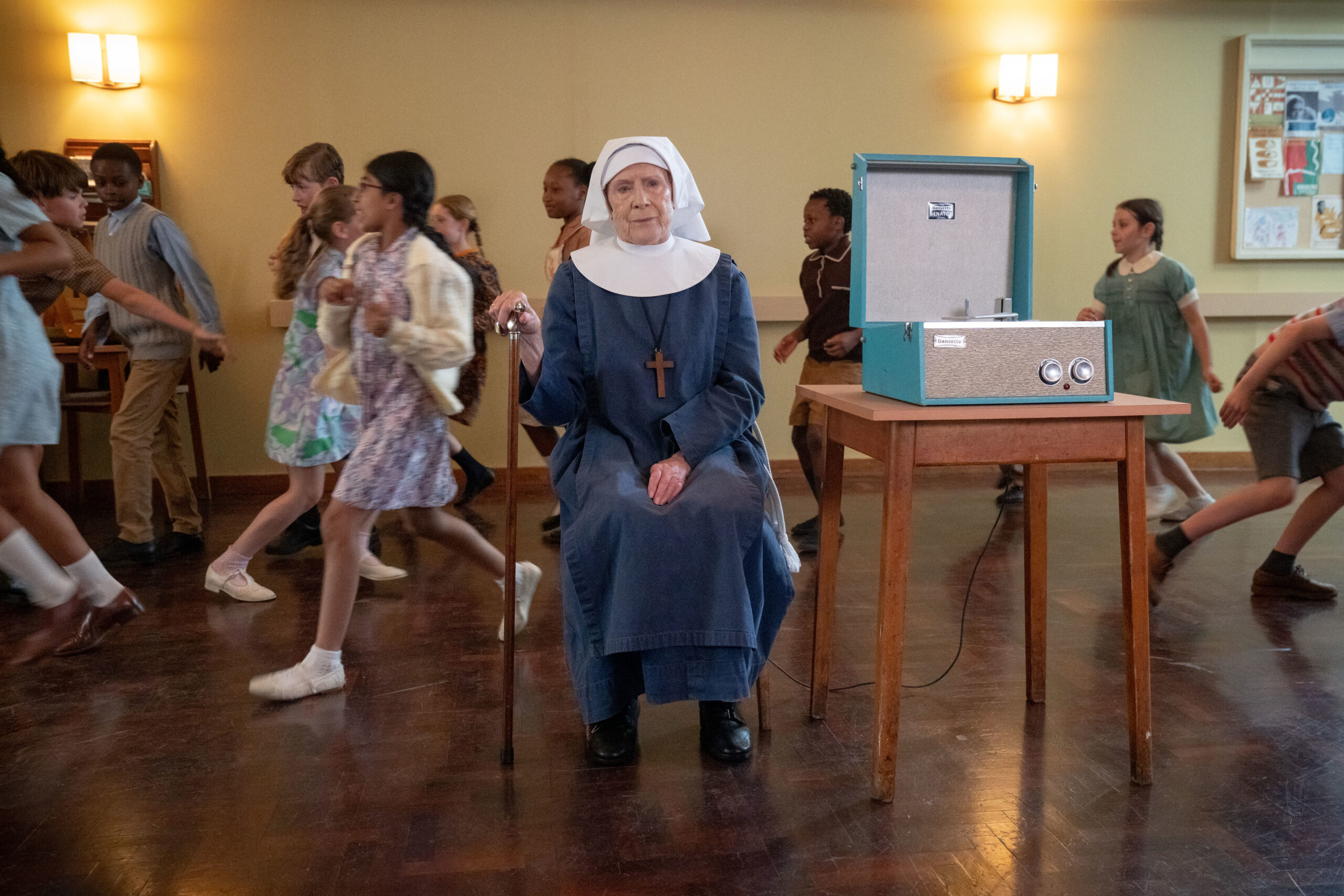 Sister Joan sits in a hall in Call the Midwife