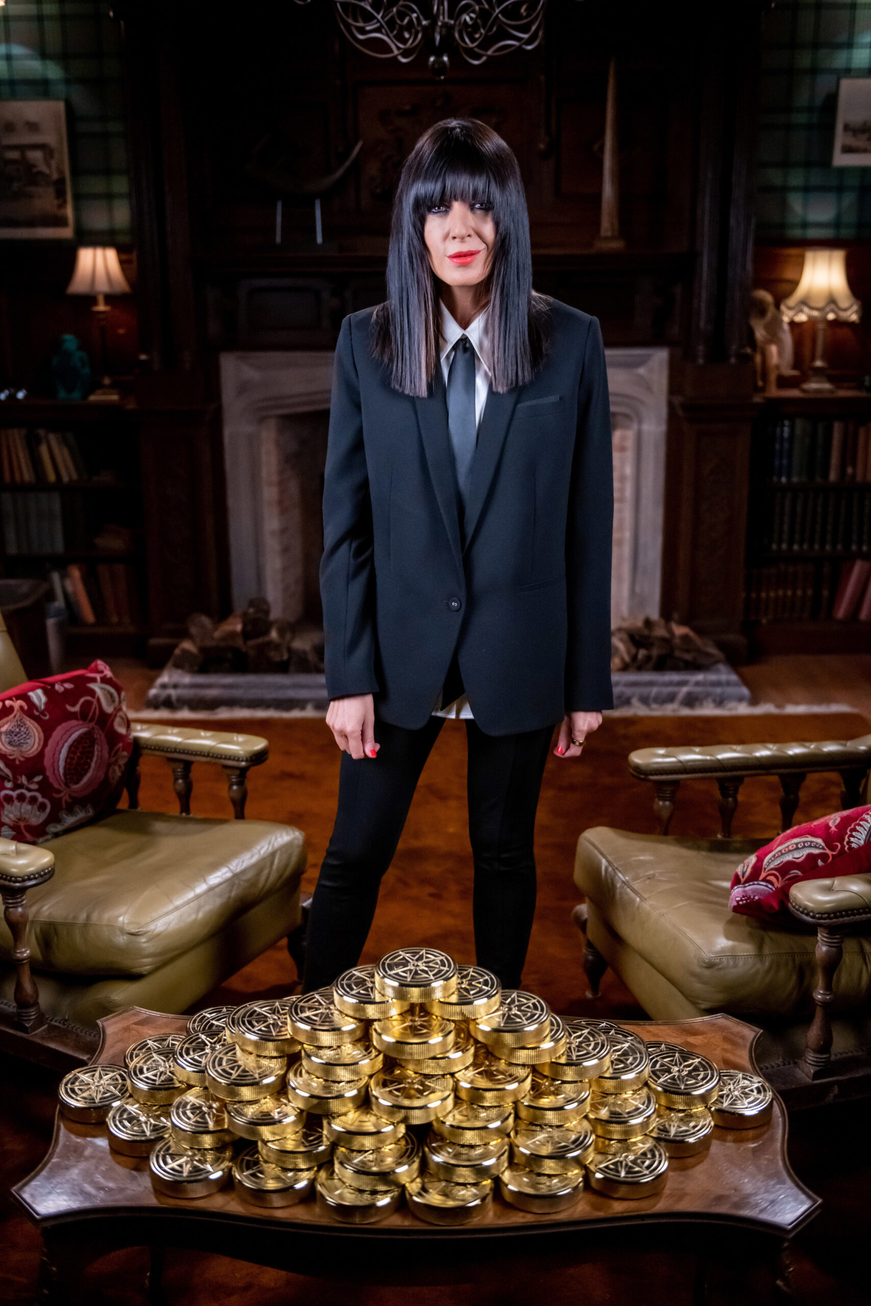 Claudia Winkleman smiles with the gold