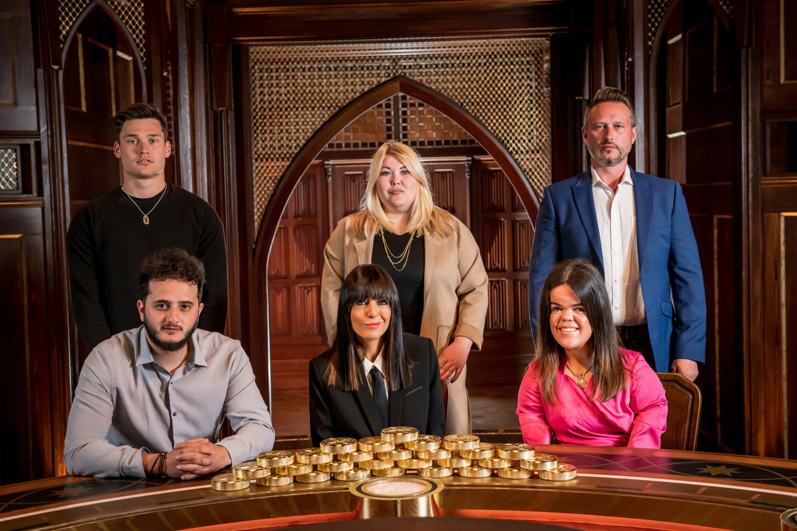 Claudia smiles with the cast of The Traitors series 1