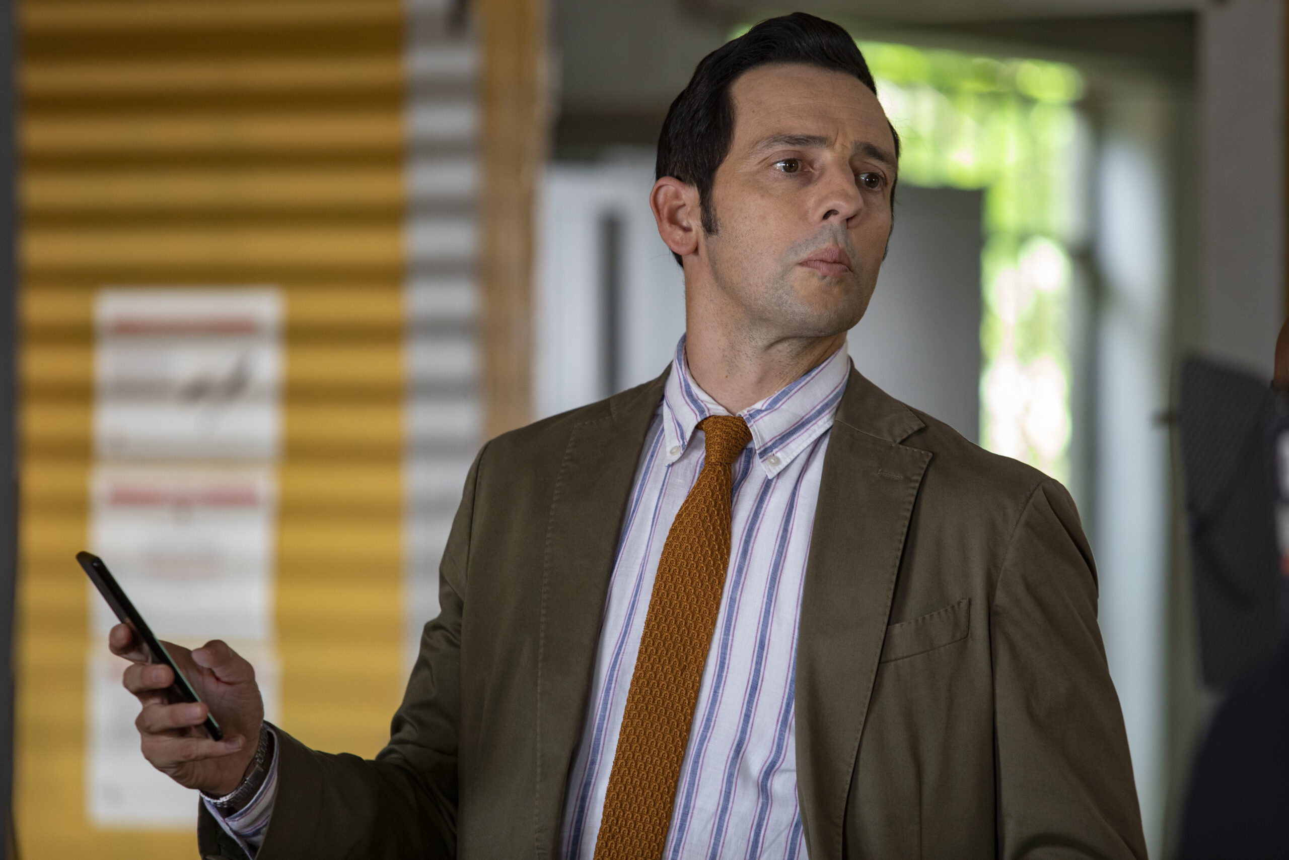 Neville Parker looks over at the team in Death in Paradise