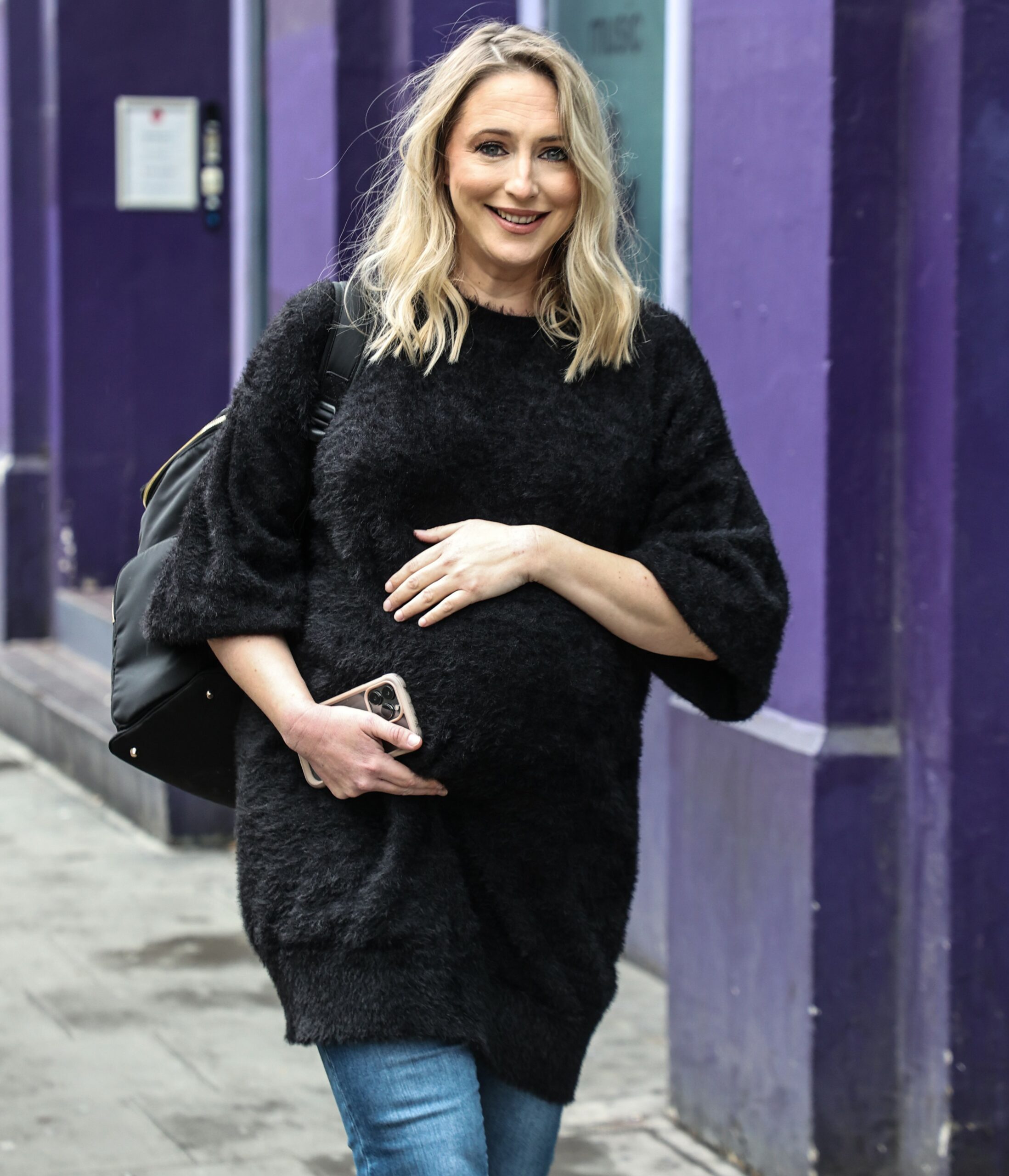 Strictly star Ali Bastian cradles baby bump as she smiles