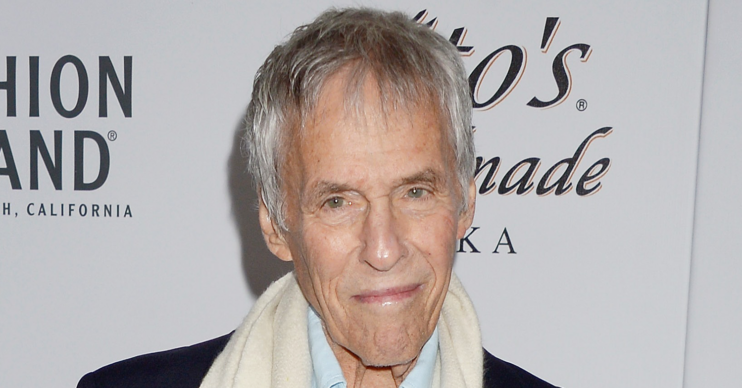 Burt Bacharach smiling on the red carpet wearing a scarf