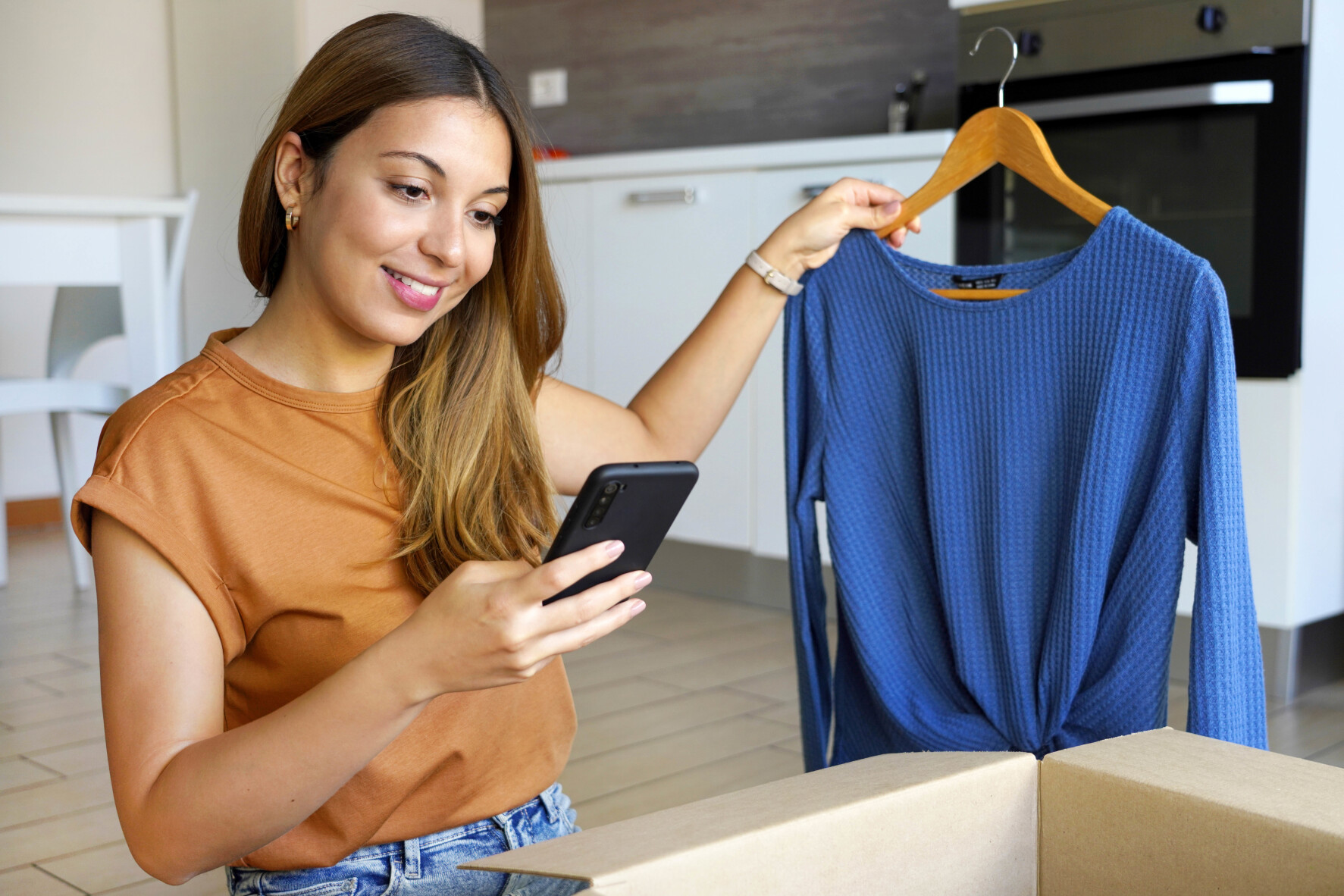 Woman smiling holding a jumper