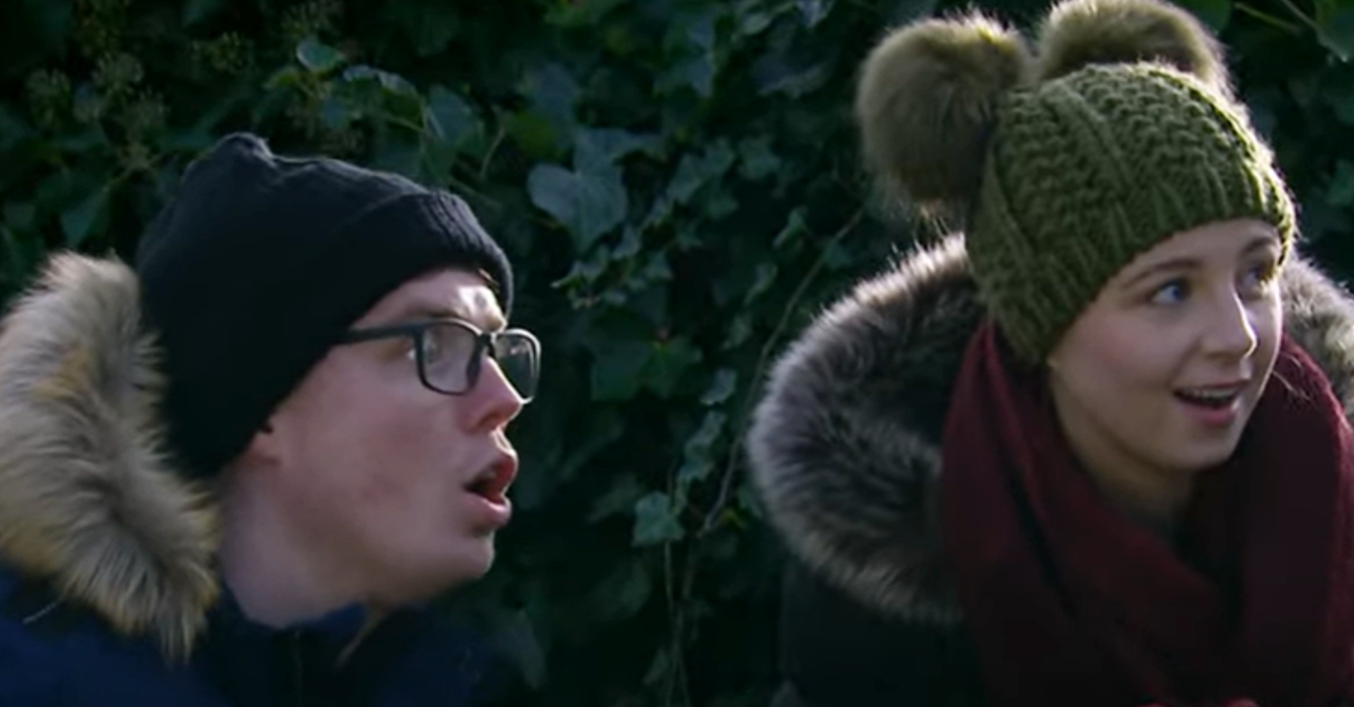 Emmerdale's Belle and Vinny are laughing together in woolly hats