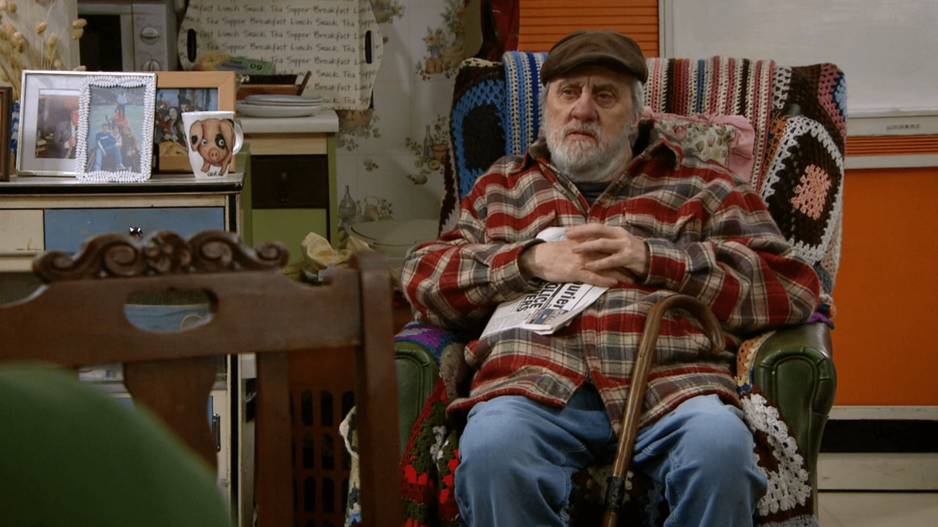 Zak in Emmerdale sits in a chair looking perplexed 