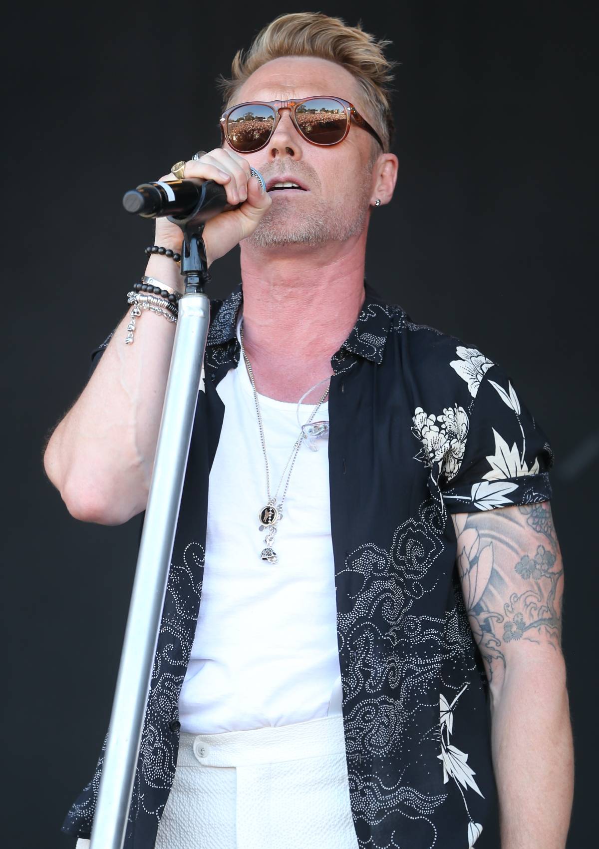 Ronan Keating singing with sunglasses on