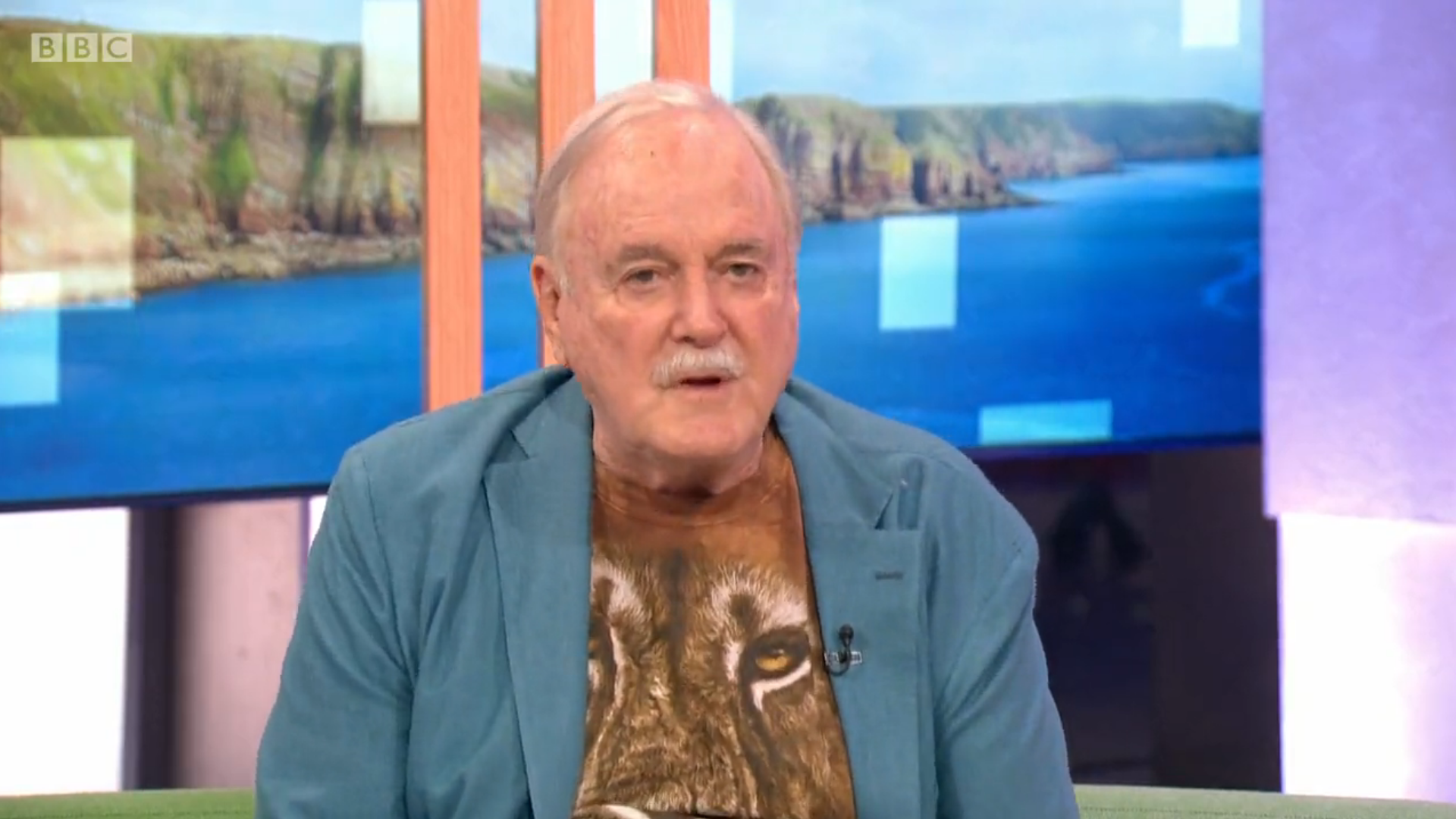 John Cleese speaks on The One Show wearing a lion T-shirt