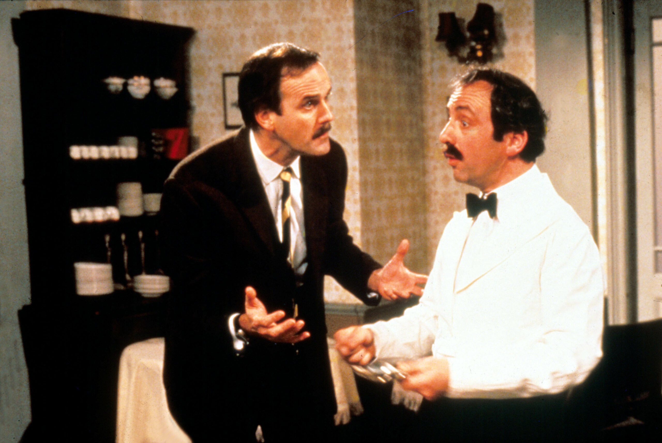 Basil speaks with Manuel in Fawlty Towers