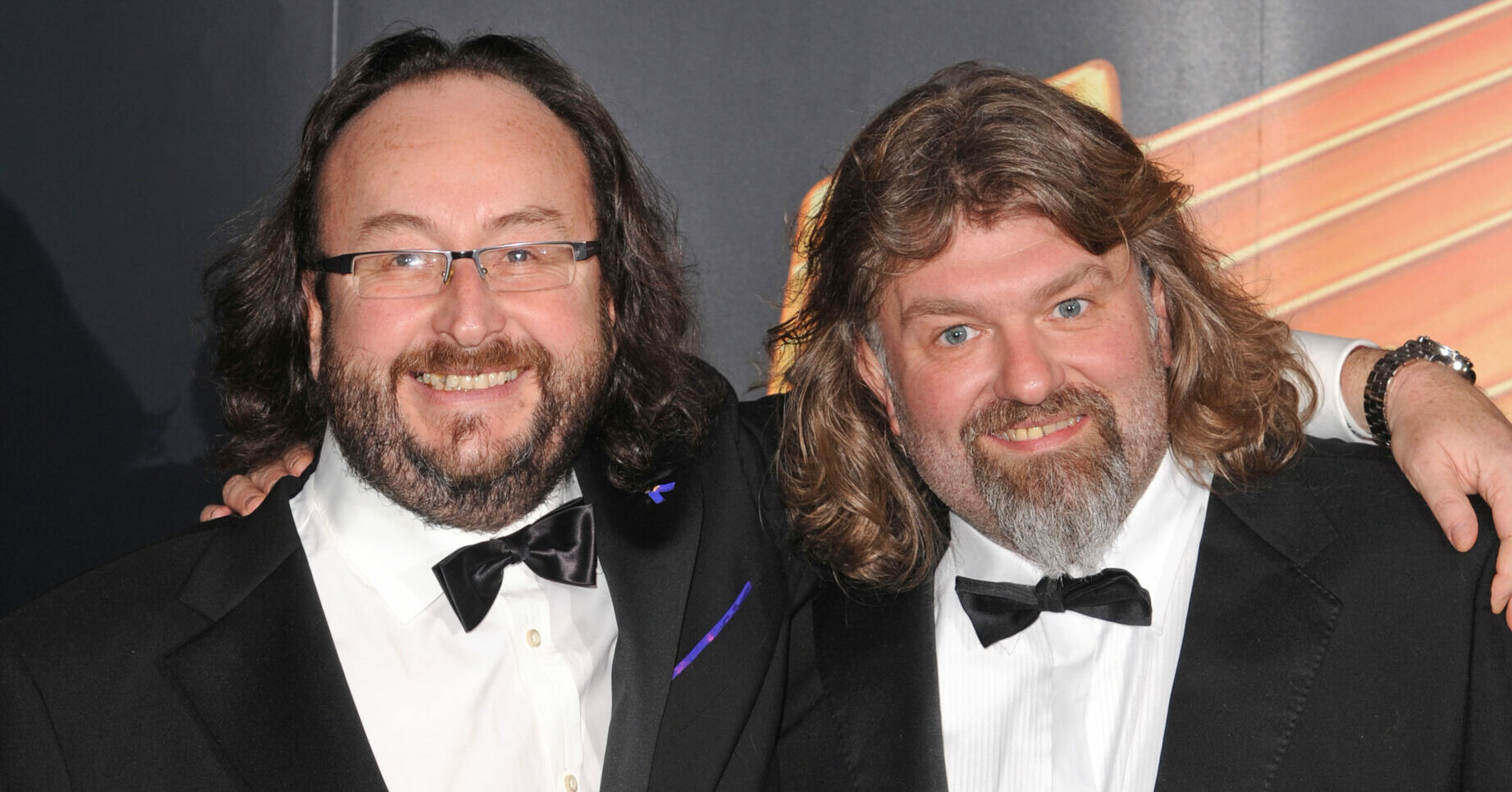 Dave Myers and Simon King smiling in tuxedos 