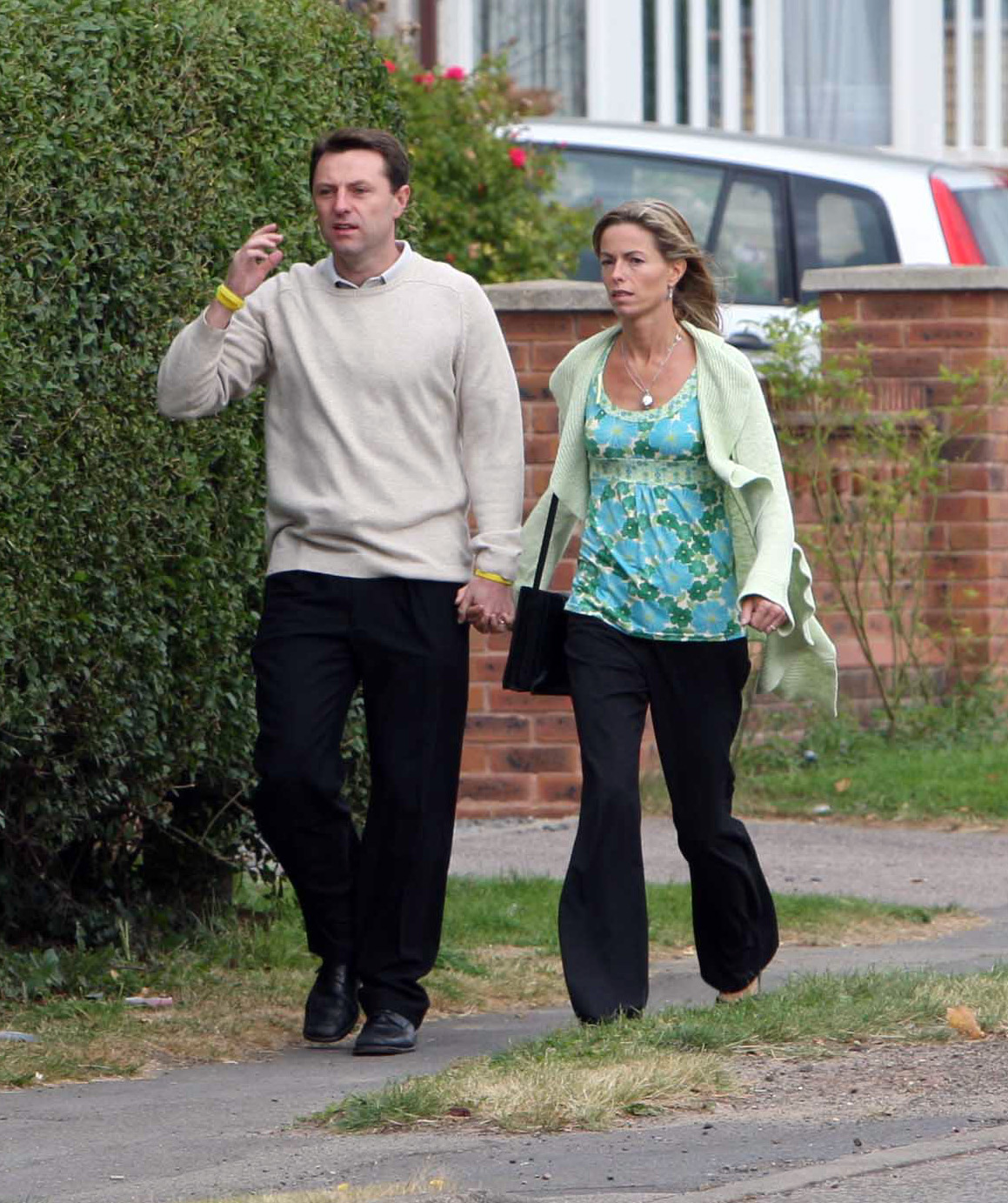 Kate and Gerry McCann holding hands in the street