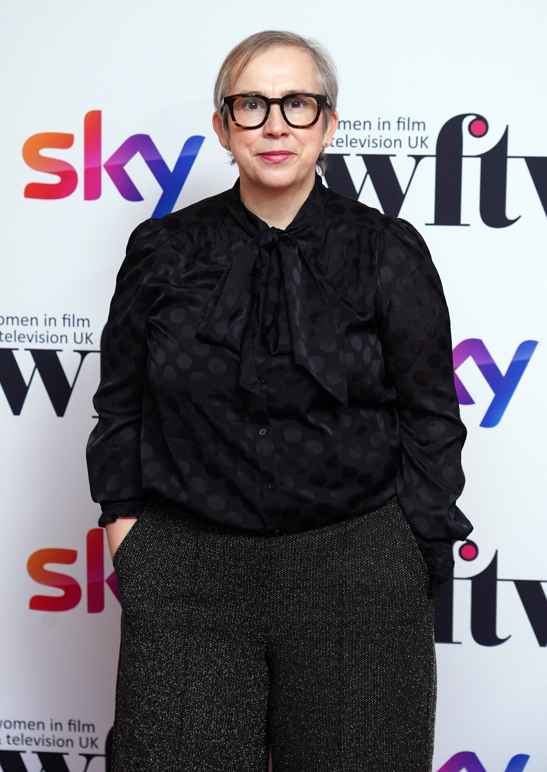 Abi Morgan wearing dark-rimmed spectacles on red carpet