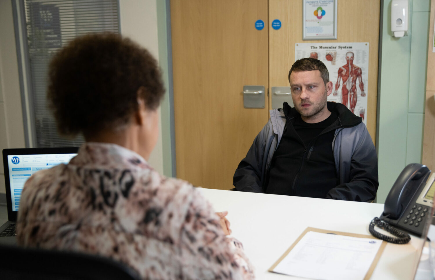Paul Foreman looks upset as the neurologist talks to him