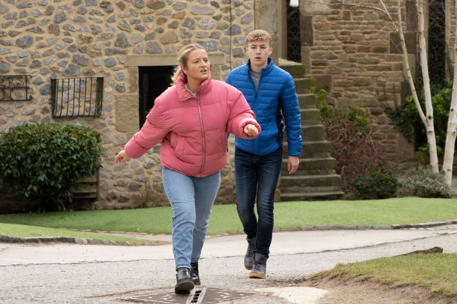 Noah follows an angry-looking Amelia, who strides ahead on Emmerdale
