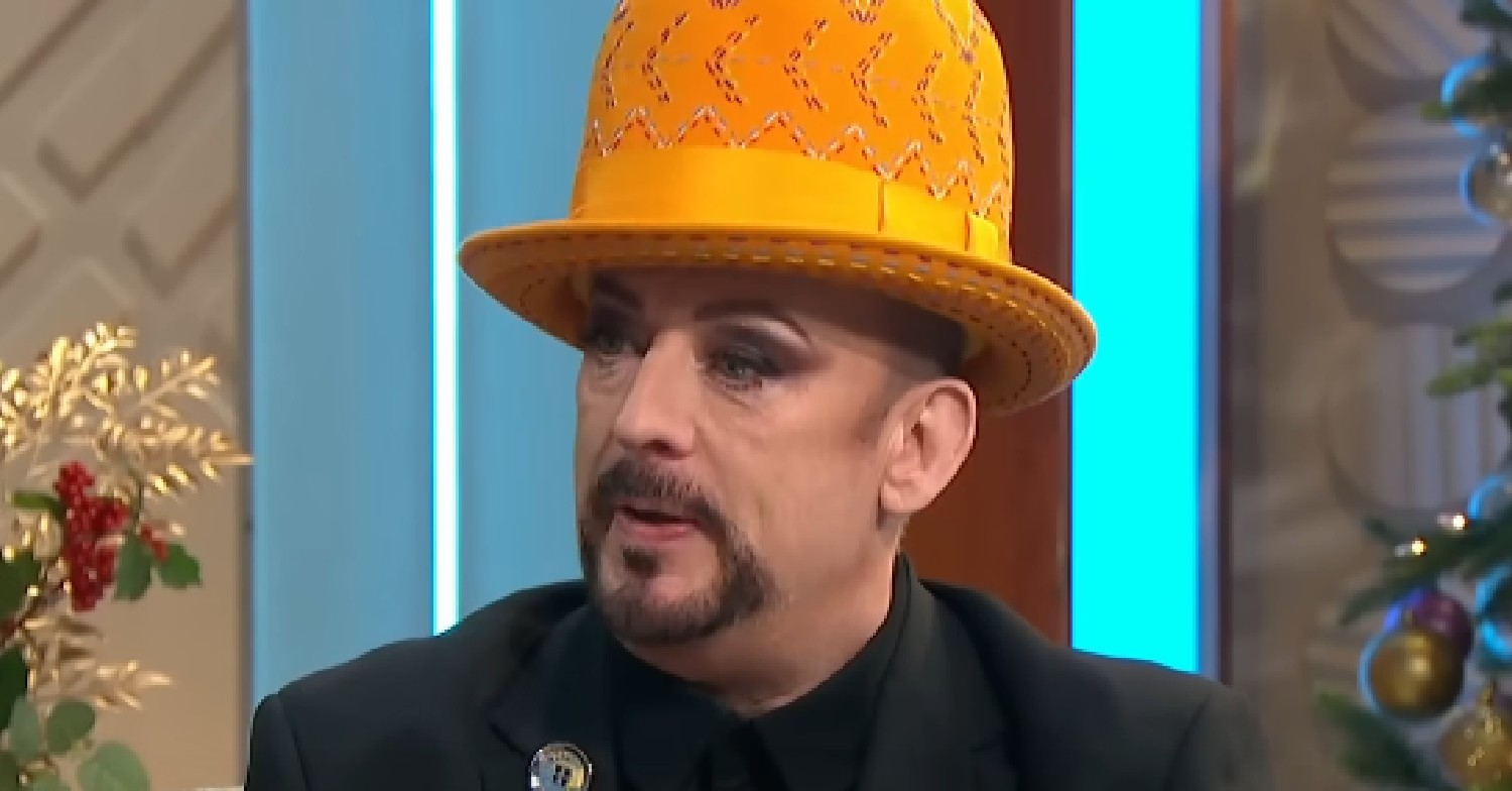 Boy George speaking on Lorraine in orange hat
